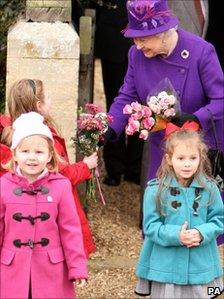 The Queen accepted flower from children after the service