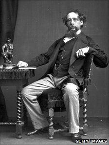 Charles Dickens sitting at desk