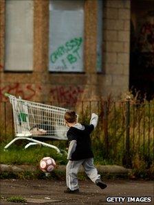 Boy in run-down Glasgow street