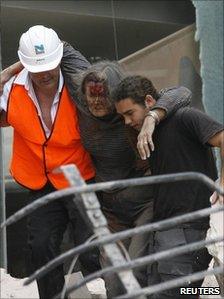 A woman is rescued from inside the Pyne Gould Corporation building after an earthquake in Christchurch