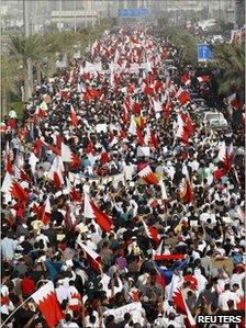 Tens of thousands of people march through the capital Manama in a rally calling for democratic reforms