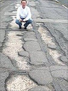 Cedar Way on Bellfields, Guildford, with potholes during an election campaign last year