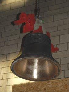 One of the new bells being hoisted into place