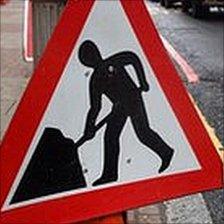 Man at work road sign