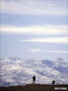 An Afghan National Army soldier standards guard at the Kabul Military Training Centre in Kabul, 24 February 2011