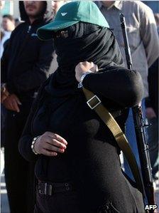 Masked armed female supporter of Col Gaddafi