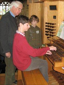 Richard Godfrey teaches a pupil to play the organ at St Mary's Church in Dorchester. Copyright of Pipe Up!