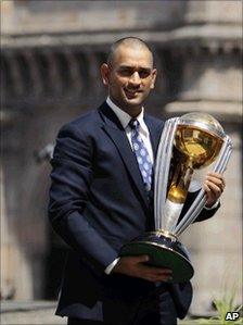 Indian captain Mahendra Singh Dhoni poses with the trophy in Mumbai on April 3, 2011