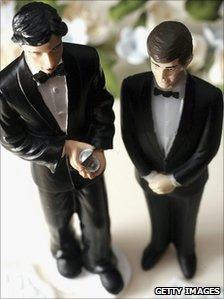 Same sex statues adorn the top of a wedding cake