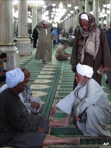 Men gather at a Sufi shrine in Cairo