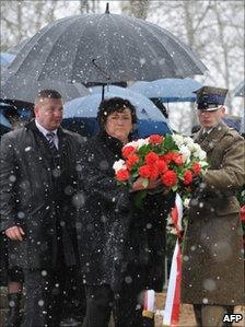 Polish first Lady Anna Komorowska prepares to lay flowers on April 9, 2011 at the monument for the 96 victims of the April 2010 plane crash during a memorial service at the Smolensk aerodrome, the site of the disaster.