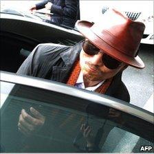 Kenichi Shinoda gets into a car after arriving at the train station in Kobe, western Japan on April 9, 2011