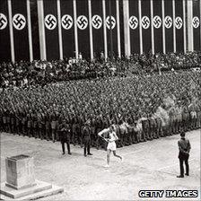 The torch is carried into the stadium in Berlin, 1936