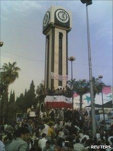 People gather at Clock Square in Homs, 18 April