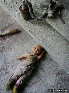 Doll and gas mask at an abandoned town