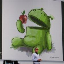 Graphic at the Google IO conference showing the Android logo eating an apple