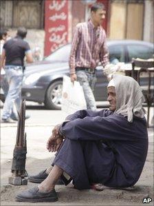 An Egyptian building worker waits on a street corner for an assignment, in Cairo, Tuesday May 10, 2011