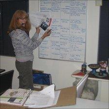 Pam records damaged contents on a whiteboard