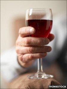 Elderly person with wine glass