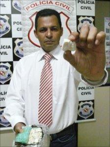 Police chief Ivanildo Santos holds a sample of oxi