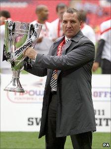 Swansea City manager Brendan Rodgers celebrates with the Championship Play Off trophy