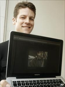 Joshua Kaufman holds up the Macbook that was stolen