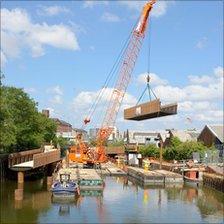 The 10.6-tonne bridge being lifted into place