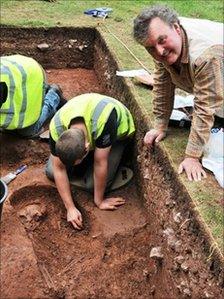 Professor Mark Horton watches as a skeleton is excavated