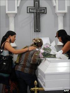 Relatives mourn next to the coffin with the remains of Ana Fabricia Cordoba, during her wake on 8 June 8, 2011 in Medellin