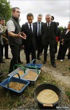 French President Nicolas Sarkozy listens to a cattle farmer at Montemboeuf, central France, 9 June