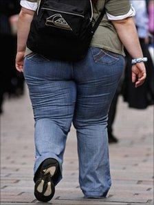 An overweight person walks through Glasgow City centre