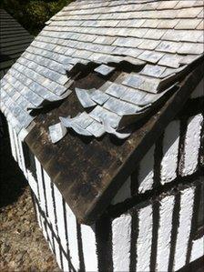 Damaged roof of Tudor-style manor house