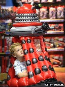 Boy tries out motorised dalek at Hamleys in London