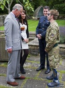 The Prince of Wales talks with Cpl Ricky Furgusson, right, who was severely injured in Sangin, last year, his girlfriend, Michelle Dodd, and medic Flt Lt Matt Haslam