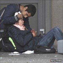 Injured woman is comforted after Oslo bombing, 22 Jul 11