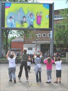 Children playing the Dash Dodge Dive game on Big Screen Swansea on Saturday