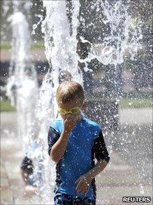 A boy standing in a fountain in Kansas City in Missouri