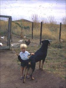 Toby the dog in front of the hen and pigeon coops in Kasinthula