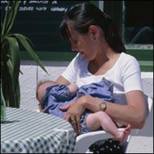 Woman breastfeeding at a cafe