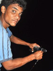 A fisherman attaches bait to a hook