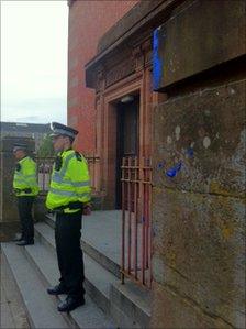 Police outside the hall in Glasgow where Nick Clegg was splattered with blue paint