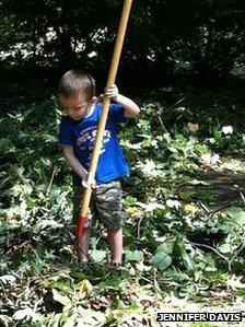 Jennifer Davis' son Wyatt helping clear fallen tree debris