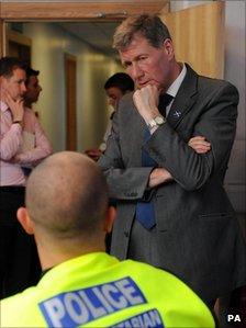 Kenny MacAskill MSP speaks to a policeman