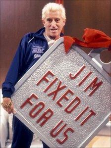 Sir Jimmy Savile with a massive Jim'll Fix It badge in 1988