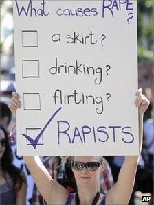 A woman holding a banner during a protest in Cape Town