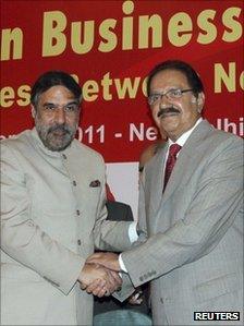 India's Trade Minister Anand Sharma and his Pakistan counterpart Makhdoom Amin Fahim (right) shake hands