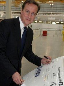 David Cameron signs a replica wing at the new North Factory