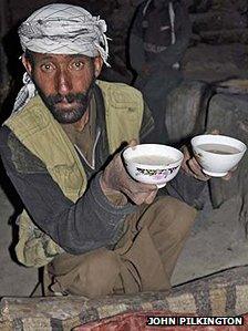 A man holding two cups of yak's-milk yogurt