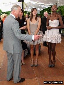 Prince Charles, Prince of Wales chats to South African models Donnet Dumas and Lukundo Nalungwe