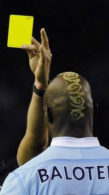 Mario Balotelli is shown a yellow card
